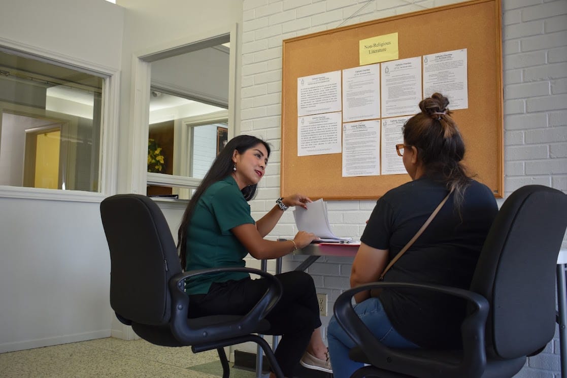 A conversation at a Catholic Charities RGV office