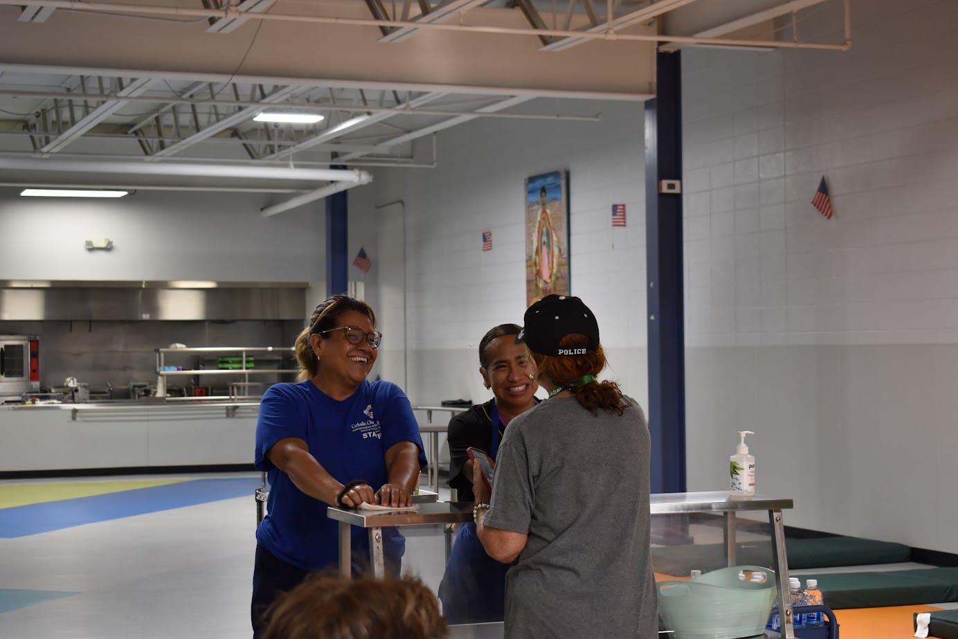 People smiling and talking at a service counter.