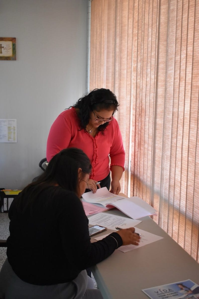 Two people reviewing paperwork at a CCRGV office