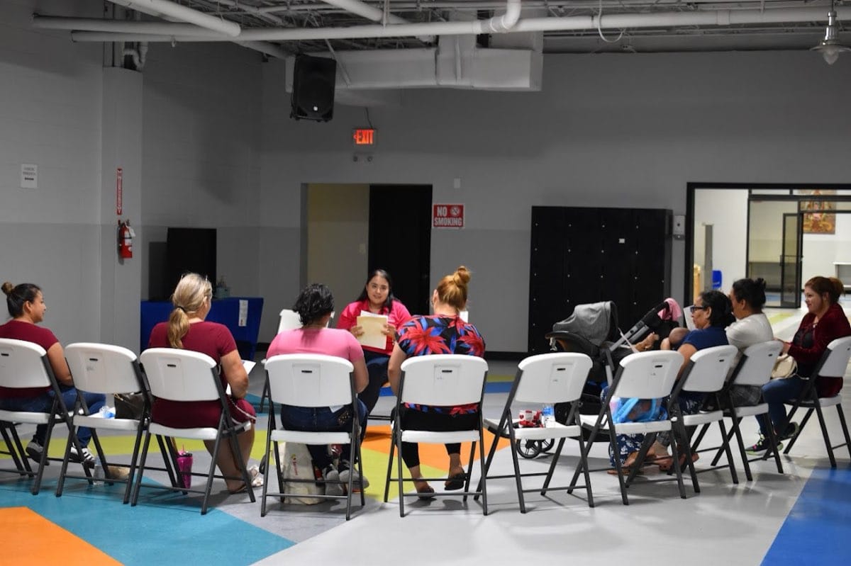People seated in a circle during a CCRGV parenting class.