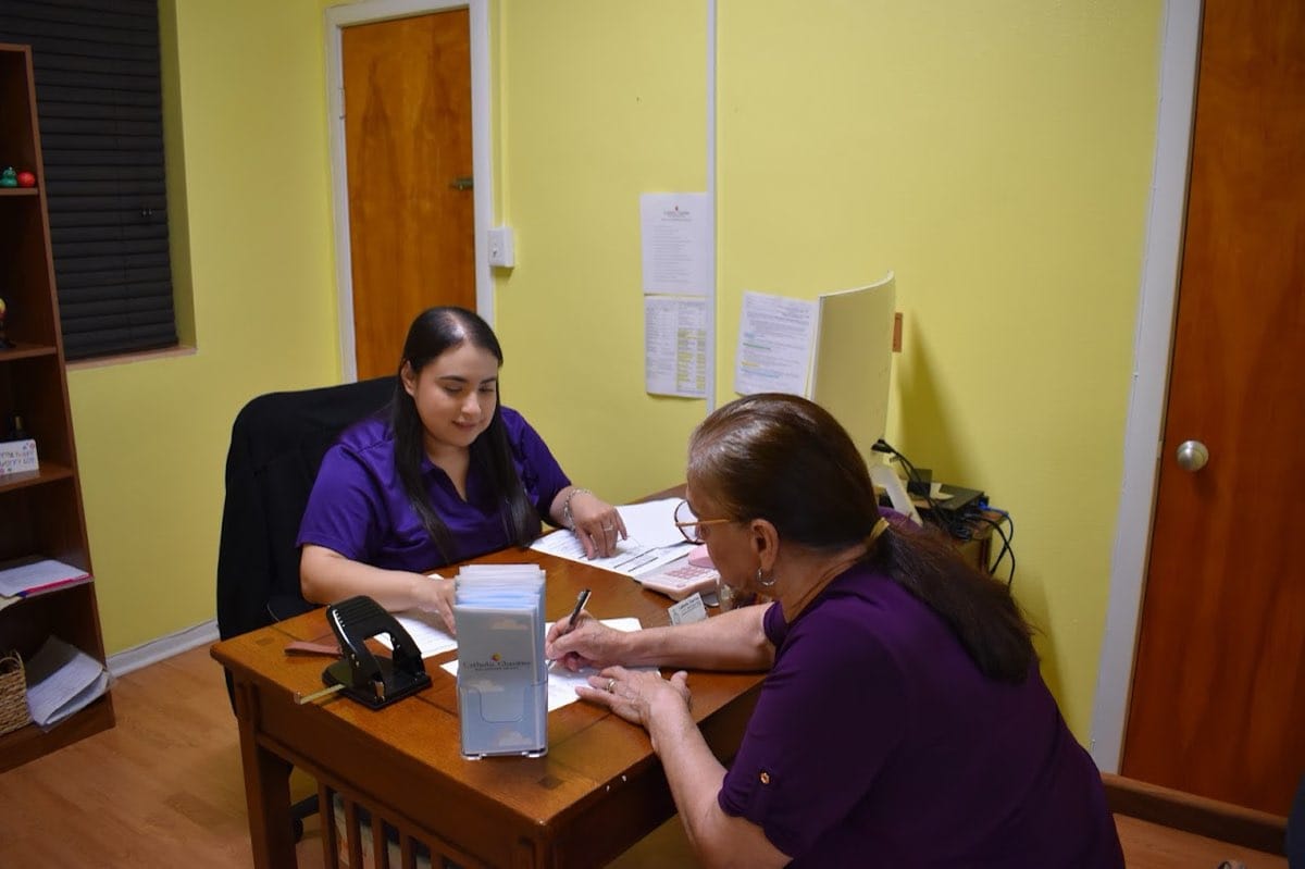 Two people reviewing documents at a CCRGV office